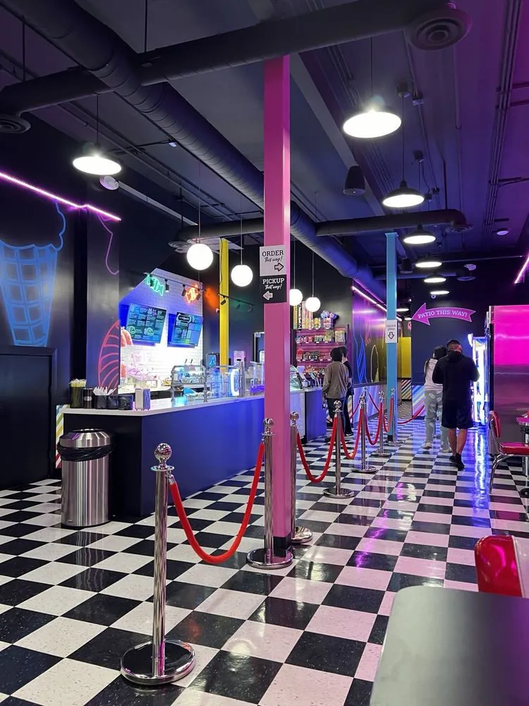 Jake's Sweet Shoppe ice cream counter with neon lighting and checkered floor